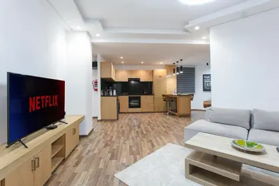 a living room with a couch and a television at The Grand Medina Hideaway - Marrakech Centre in Marrakech
