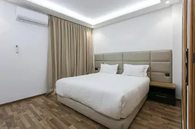 a bedroom with a large bed with white sheets at The Grand Medina Hideaway - Marrakech Centre in Marrakech