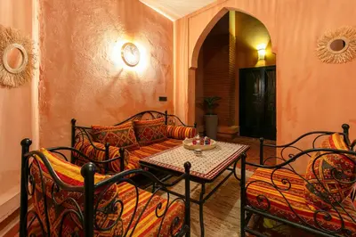 a living room with a couch and a table and chairs at The Grand Medina Hideaway - Marrakech Centre in Marrakech