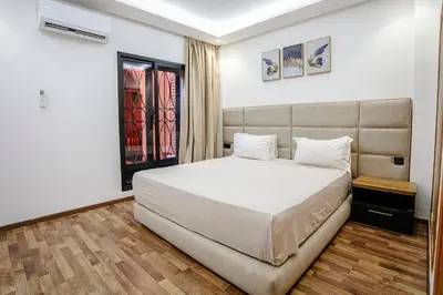 a bedroom with a large white bed and a window at The Grand Medina Hideaway - Marrakech Centre in Marrakech