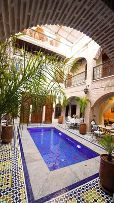 a swimming pool in the middle of a building at Riad Touhfa Kasbah Marrakech in Marrakech