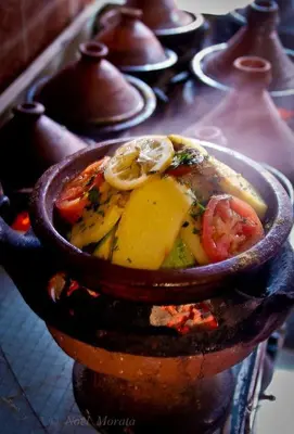 a bowl of food with tomatoes and other vegetables at Riad Arabesque in Marrakech