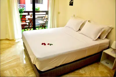 a bed with flowers on it in a room at Luxurious KING Bed SUITE W/POOL. Well centered. in Marrakech