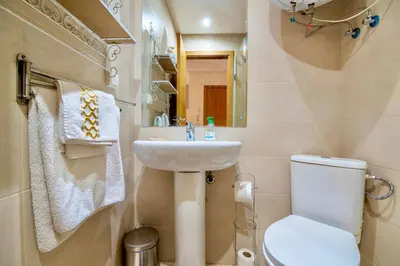 a small bathroom with a toilet and a sink at Luxurious KING Bed SUITE W/POOL. Well centered. in Marrakech