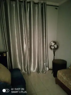 a room with a window with curtains and a fan at Chrifia in Marrakech