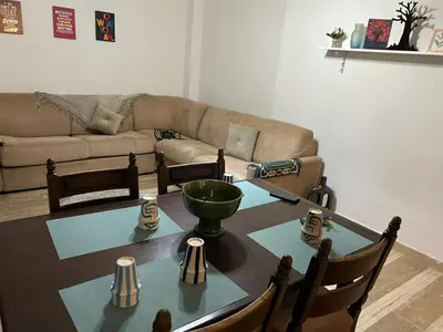 a living room with a table and a couch at belle appartement a Marrakech in Marrakech