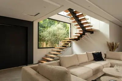 a living room with a couch and a staircase at Villa Design à Marrakech in Marrakech