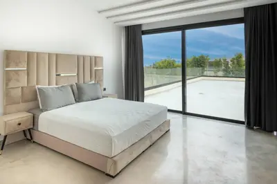 a bedroom with a large bed and a large window at Villa Design à Marrakech in Marrakech