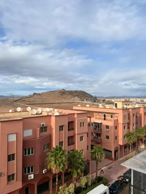 a view of an apartment complex with palm trees at Appartement Marrakech Gueliz 5 Min Drive to City Center in Marrakech