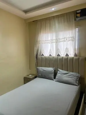 a bedroom with a white bed with a window at Appartement Marrakech Gueliz 5 Min Drive to City Center in Marrakech