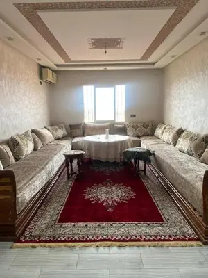 a living room with a large couch and a table at Appartement Marrakech Gueliz 5 Min Drive to City Center in Marrakech