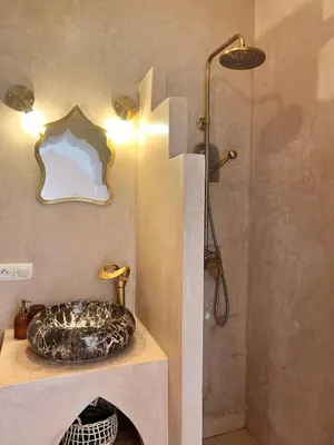 a bathroom with a sink and a shower at Riad Jardin de Malia in Marrakech
