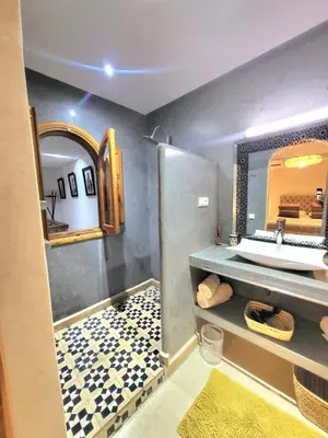 a bathroom with a sink and a mirror at Riad Melilo avec piscine chauffée in Marrakech