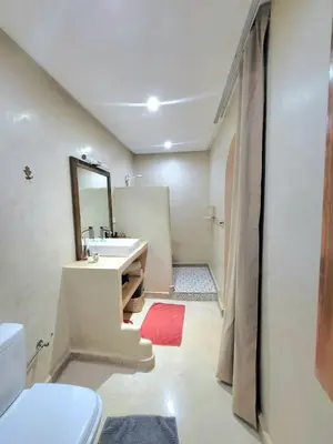 a bathroom with a sink and a mirror at Riad Melilo avec piscine chauffée in Marrakech