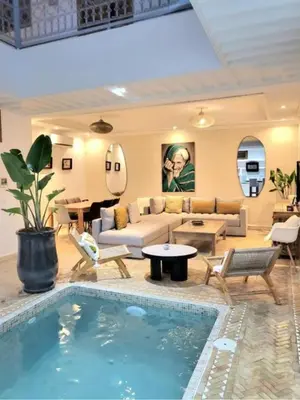 a living room with a couch and a swimming pool at Riad Melilo avec piscine chauffée in Marrakech