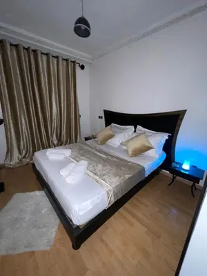 a bedroom with a large bed with white sheets and pillows at Apartment Gueliz in the best location in Marrakesh in Marrakech