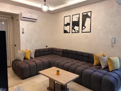 a living room with a couch and a coffee table at NOOR 5 Residence in Marrakech