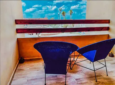 two chairs and a table in a room at NOOR 5 Residence in Marrakech