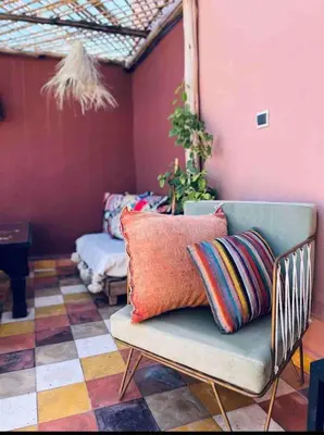 a couch with pillows on it in a room at Dar Mawa, a 1 min de Jemaa el Fna in Marrakech