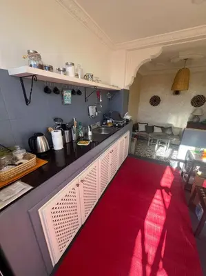 a kitchen with a red rug on the counter at Dar Mawa, a 1 min de Jemaa el Fna in Marrakech