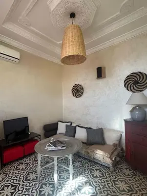 a living room with a couch and a table at Dar Mawa, a 1 min de Jemaa el Fna in Marrakech