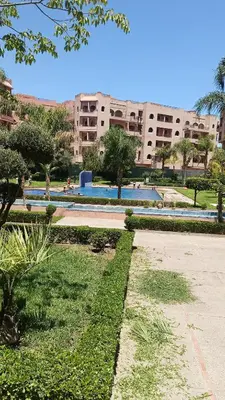 a park in front of a large building at premium village 106 in Marrakech