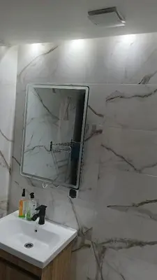 a bathroom with a sink and a mirror on a wall at premium village 106 in Marrakech