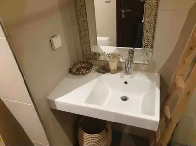a bathroom with a white sink and a mirror at Studio au centre in Marrakech