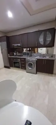a kitchen with a stove and a microwave at Studio au centre in Marrakech
