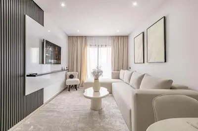 a white living room with a couch and a table at Brand New! Charming and Comfortable Flat in Gueliz in Marrakech
