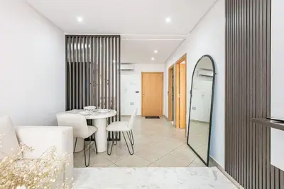 a dining room with a table and chairs and a mirror at Brand New! Charming and Comfortable Flat in Gueliz in Marrakech