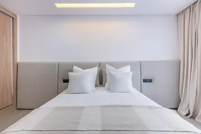 a bedroom with a bed with white pillows at Brand New! Charming and Comfortable Flat in Gueliz in Marrakech