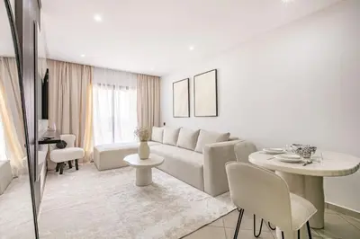 a white living room with a couch and a table at Brand New! Charming and Comfortable Flat in Gueliz in Marrakech