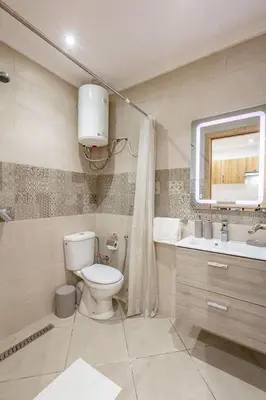 a bathroom with a toilet and a sink and a mirror at Brand New! Charming and Comfortable Flat in Gueliz in Marrakech
