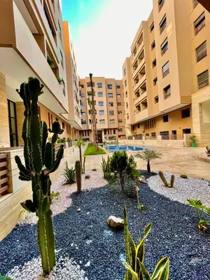 a courtyard with cacti and plants in a building at Deluxe KING Bed SUITE W/POOL in Marrakech