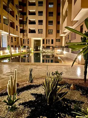a building with a pool in the middle of a courtyard at Deluxe KING Bed SUITE W/POOL in Marrakech
