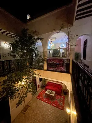 an overhead view of a living room with a red couch at RIAD GJULJA in Marrakech
