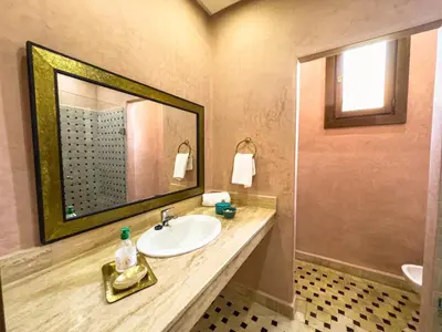 a bathroom with a sink and a mirror at Riad Tonaroz in Marrakech
