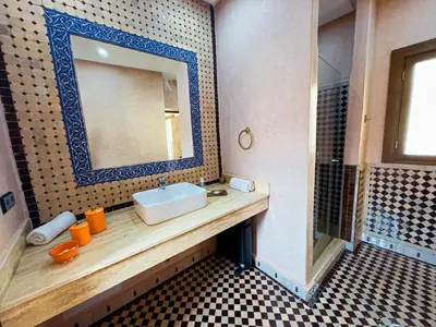 a bathroom with a sink and a mirror at Riad Tonaroz in Marrakech