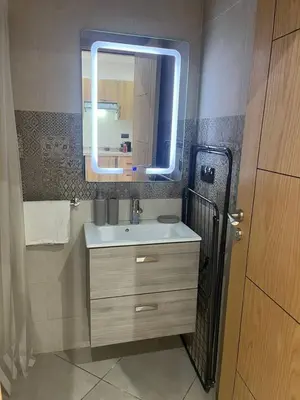 a bathroom with a sink and a mirror at New ! Logement Chic, Emplacement Idéal in Marrakech