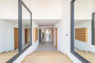 a hallway with large mirrors in a white building at New ! Logement Chic, Emplacement Idéal in Marrakech