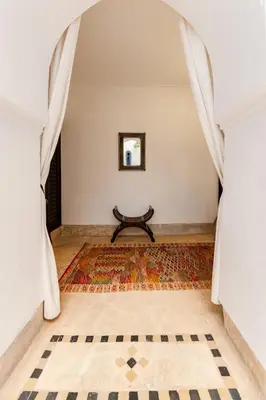 a hallway with a table in the middle of a room at Riad Rouge Gorge in Marrakech
