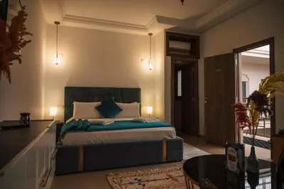 a bedroom with a large bed with blue pillows at Riad Kenza in Marrakech