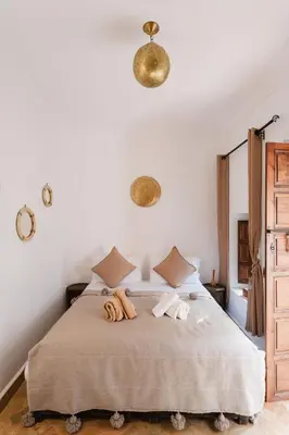 a bedroom with a bed with two towels on it at Riad of the Moon in Marrakech