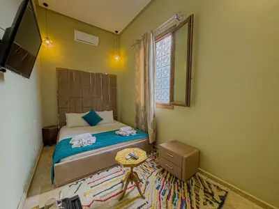 a bedroom with a bed with two towels on it at Riad Azia in Marrakech