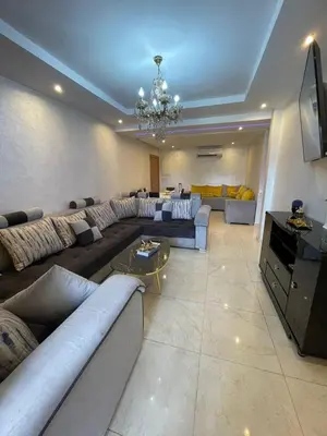 a large living room with couches and a television at Appartement de rêve à Marrakech in Marrakech