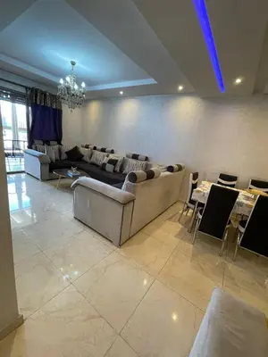 a living room with couches and tables and chairs at Appartement de rêve à Marrakech in Marrakech