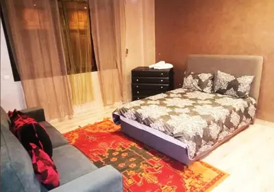 a bedroom with a bed and a couch at Hostel Ghali & Private Rooms Gueliz in Marrakech