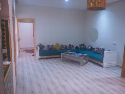 a living room with a blue couch and a table at Hostel Ghali & Private Rooms Gueliz in Marrakech