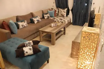 a living room with a couch and a table at Residence Miramas 2 D in Marrakech
